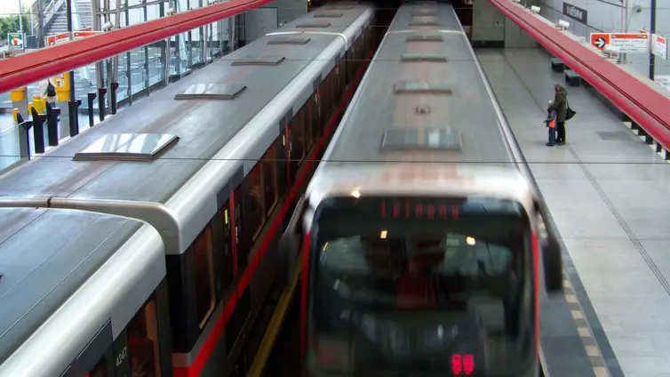 2 Prague metro trains, side by side in a station.