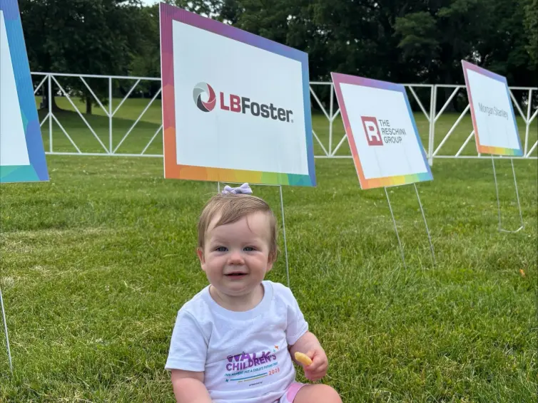 Baby sitting in grass. Bryan McSorley's daughter Rylan McSorley fueling up for the walk.
