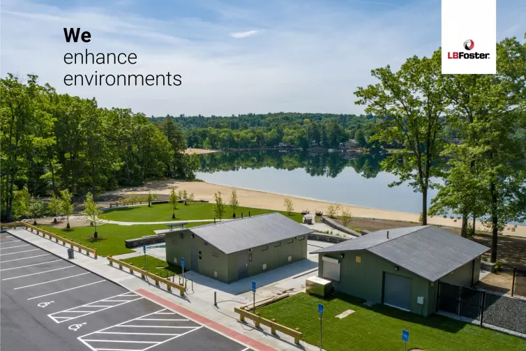 A birdseye view of two CXT concrete precast buildings within a small park area. There are many trees in the distance and a large lake. text on the image says 