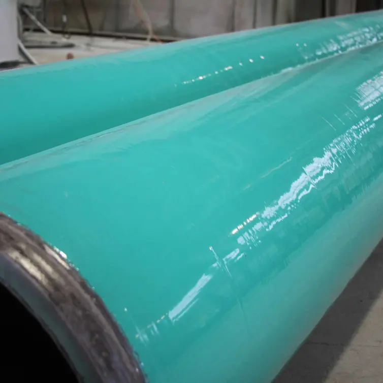 Close-up of two teal coated pipes laid side by side.