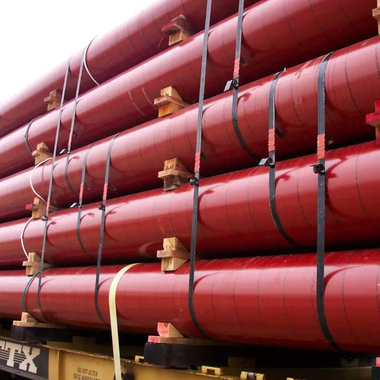 Five pieces of red threaded pipe on a truck bed.