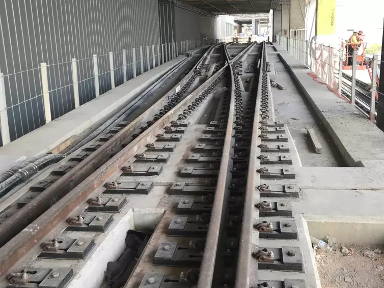 crossing train tracks showing rail and fasteners.
