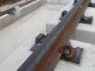 close-up of a train track showing fasteners and rail