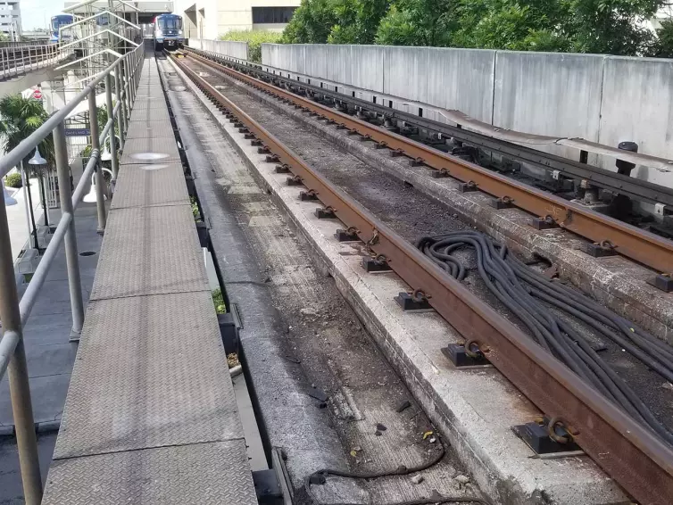 suspended train tracks shown with oncoming train.