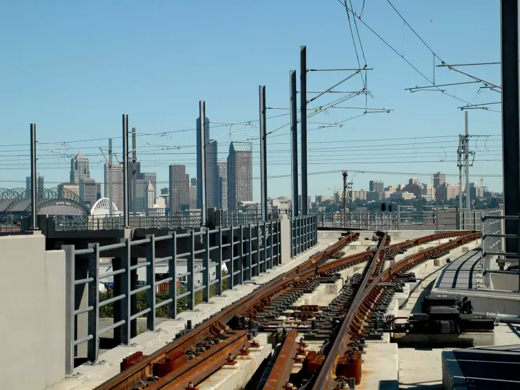 railroad track shown with city skyline in the background.