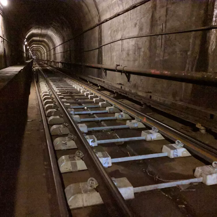 two block rail ties show in tracks inside subway.