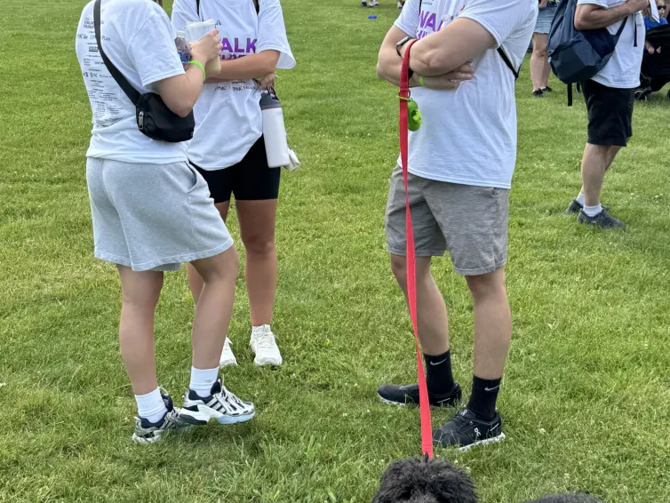 Group talking with a dog. (L-R) Heather, Bella, Mark, and Jack the family dog.
